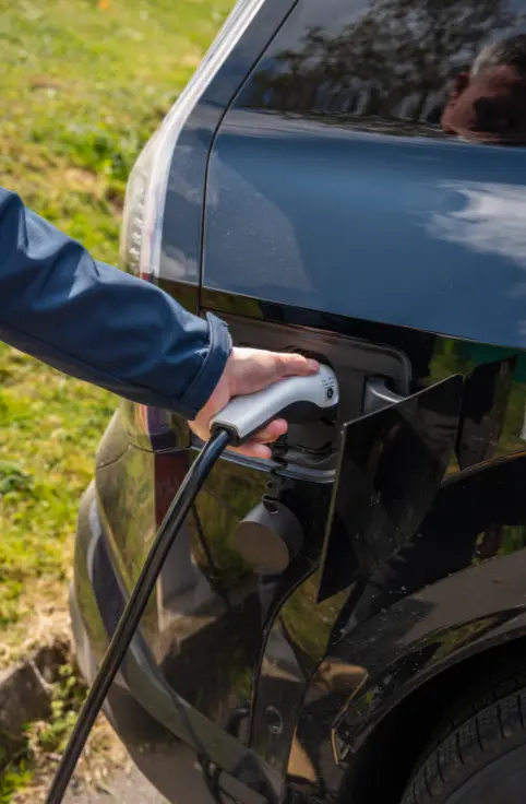 An electric vehicle being connected to a charger
